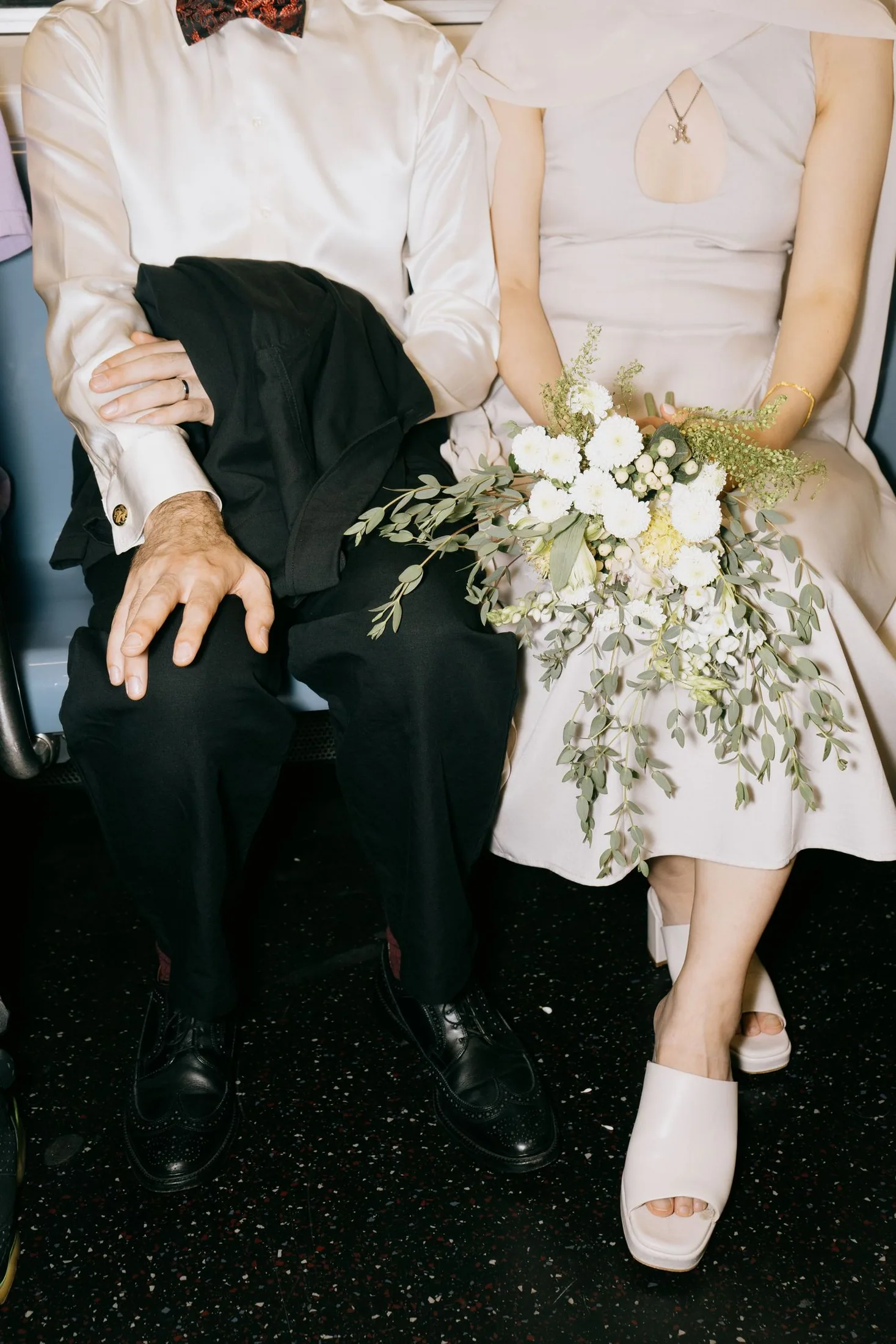 Wedding bouquet, rings, and formalwear photographed as quiet details