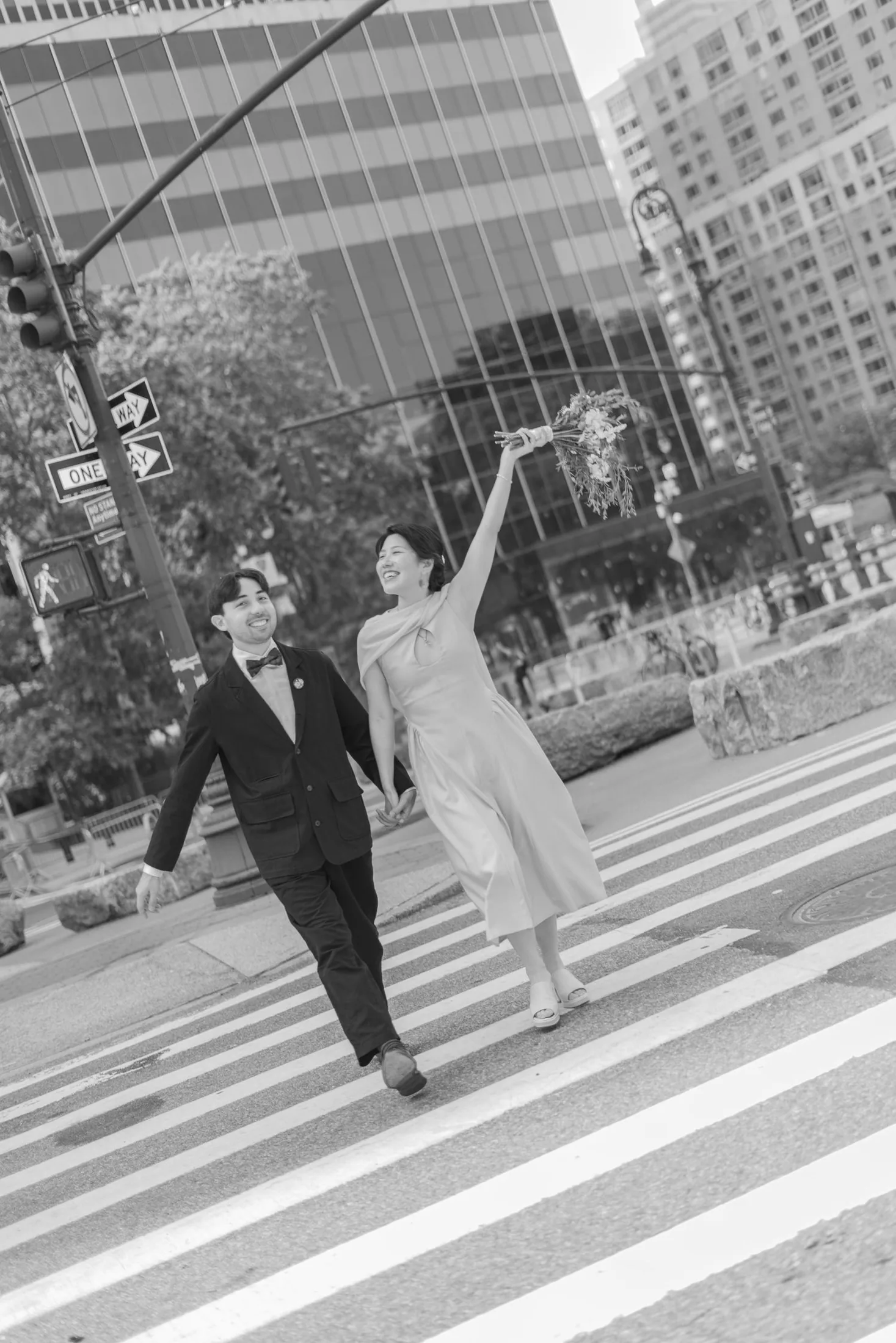 Newlyweds crossing a New York City street in black and white